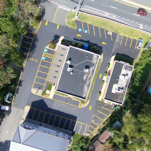 Overhead view of commercial parking lot with line striping freshly painted
