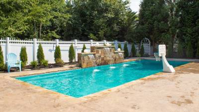 Rectangular fiberglass pool installed includes fountain and coral blue color