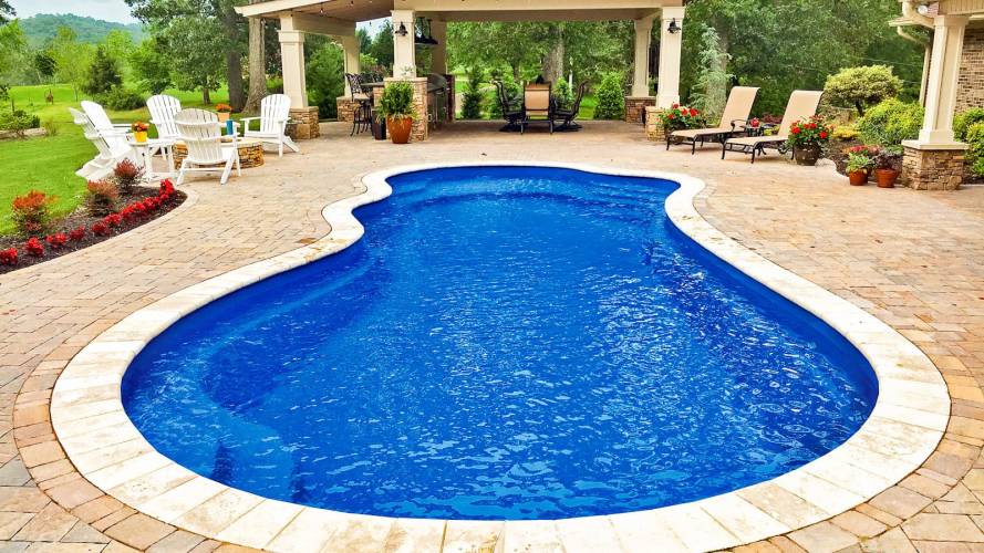 Round, natural shaped fiberglass pool shape installed
