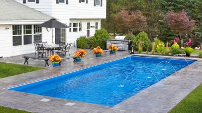 Backyard inground pool with fountains